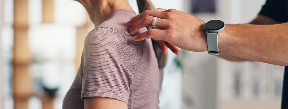 Shoulder pain physiotherapy and consulting with old woman