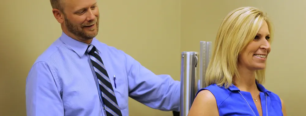 Chiropractor checking woman's posture